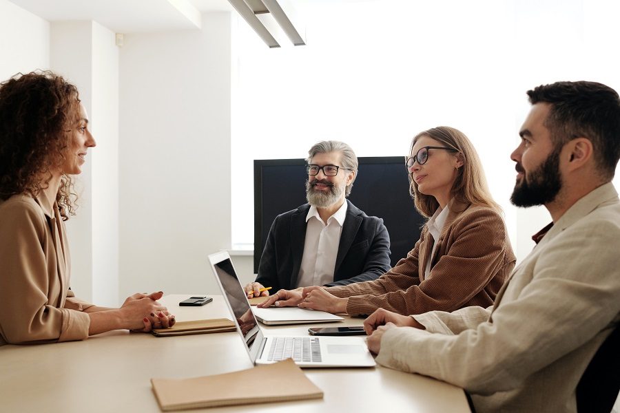 Consultants meeting with a client around a table